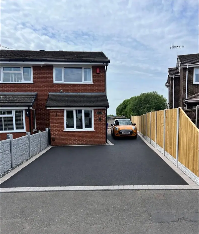 Finished tarmac driveway with block edging and new panel fencing