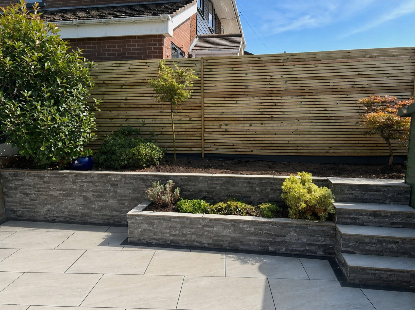 Raised planters, paving and slatted fencing completed by RB Landscapes