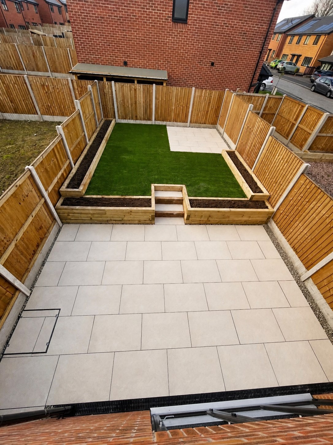Paved patio, raised timber beds and lawn
